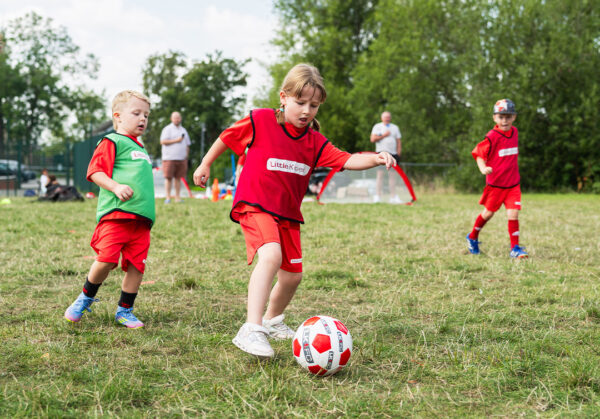 a group of kids playing football