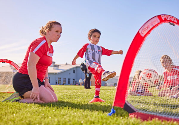 a person and a child playing football